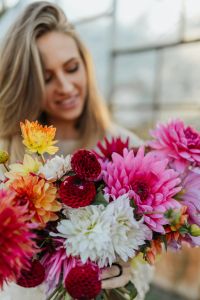 Kaboompics - Woman Looking At Mixed Dahlia Bouquet