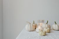Kaboompics - White Pumpkins with Candle in a Bright Minimal Setting