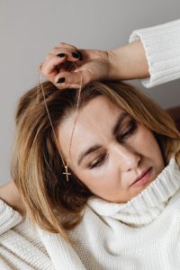 Kaboompics - Woman Resting with Closed Eyes and a Gold Cross Necklace