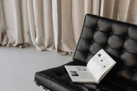Kaboompics - Neutral Reading Corner with Open Book on a Leather Lounge Chair