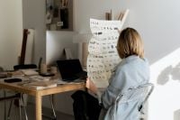 Kaboompics - Interior Designer Reviewing Furniture Catalog in Creative Studio