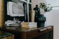 Kaboompics - Books, Vases and Folded Textiles on Marble-Topped Wooden Commode