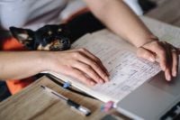 Kaboompics - Woman working on her laptop with her dog