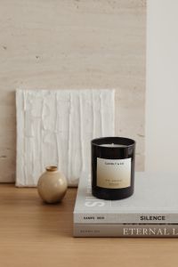 Kaboompics - Scented Candle on Design Books with Textured Wall Relief