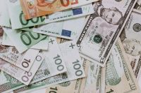 Kaboompics - Overlapping Polish Zloty, US Dollar and Euro Notes on a White Background