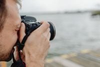 Kaboompics - Photographer holding a DSLR camera