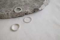 Kaboompics - Silver Rings on Gray Stone and White Fabric – Fujifilm X100VI