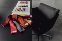 Kaboompics - Color Swatch Books and Textiles Beside a Gray Office Chair in a Design Studio