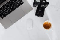 Kaboompics - Coffee, laptop and camera on a white marble table