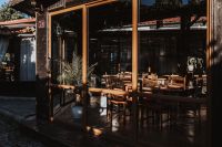 Kaboompics - Glass-Front Restaurant with Wooden Dining Tables