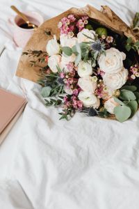 Kaboompics - Overhead View of a Hand-Tied Bouquet on White Bedding