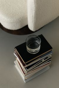 Kaboompics - Minimalist Living Room Detail with Glass of Water on Books