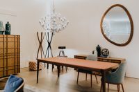 Kaboompics - Modern Dining Room with Wood Table, Chandelier and Round Wall Mirror
