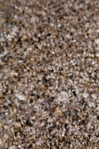 Kaboompics - Abstract Coastal Pebble Texture with Soft Water Bokeh
