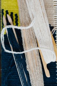 Kaboompics - Vertical Detail of Textured Green Yarn and Fringe