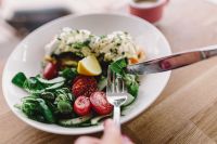 Kaboompics - Close up image of young woman eating classic breakfast at restaurant