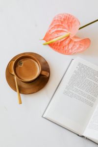 Kaboompics - Coffee and Pink Anthurium with Open Book
