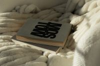 Kaboompics - Book on Plush Cream Blanket in Warm Reading Nook