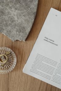 Kaboompics - Gray Marble Sample, Open Pages and Glass Dish on Oak