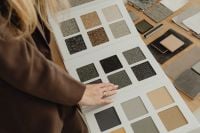 Kaboompics - Close-Up of Hands Reviewing Material Sample Book