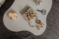 Kaboompics - Neutral Christmas Gift Wrapping Flat Lay with Ribbon, Scissors and Candles