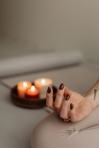Kaboompics - Meditation Mudra Hand With Candles in the Background