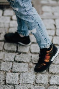 Kaboompics - Woman in black sneakers and blue jeans