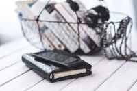 Kaboompics - Black Planner in Front of a Wire Basket Filled with Books