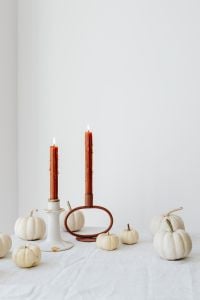 Kaboompics - Wide White Pumpkin and Taper Candle Display on a Warm Neutral Background