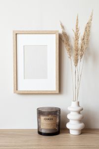Kaboompics - Vertical Wooden Frame Mockup with Pampas Grass and Candle for Neutral Wall Art