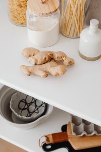 Kaboompics - Fresh Ginger Root with Glass Jars of Pasta and Flour on a Kitchen Counter