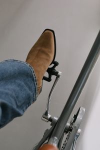 Kaboompics - Tan Suede Boots on an Exercise Bike for Urban Lifestyle Concept