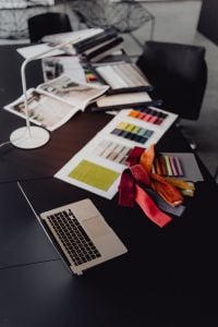 Kaboompics - Bright Upholstery Fabric Swatches and Draped Textiles on a Black Studio Table