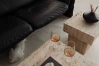 Kaboompics - Black Leather Sofa and Open Book on Travertine Table