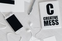 Kaboompics - Black and White Creative Mess Notebook with Phone and Earphones