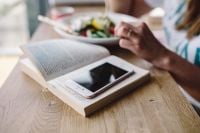 Kaboompics - Woman eating breakfast and reading a book