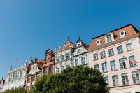 Kaboompics - Colorful Gdańsk Old Town Gables Framed by Green Tree Canopy