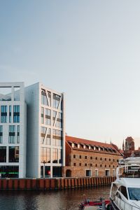 Kaboompics - Vertical Gdańsk Waterfront Architecture with Modern White Building, Brick Warehouse and Yacht