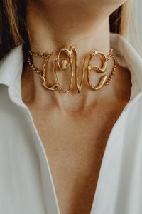 Kaboompics - Gold Statement Choker Necklace on Woman in White Shirt