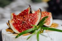 Kaboompics - Macro Fig Wedges and Rosemary on Camembert with Grapes Blurred