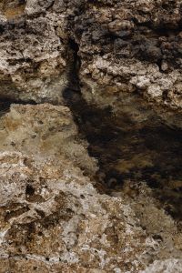 Kaboompics - Clear Seawater Pooling in a Pitted Limestone Channel