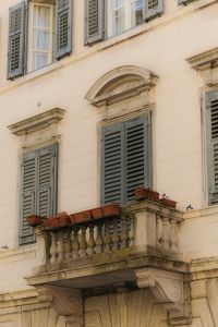 Kaboompics - Green Shutters and Stone Balcony on a Historic Italian Building
