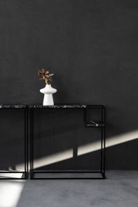 Kaboompics - White Sculptural Vase with Dried Flower on Black Marble Console, Sunlit Interior