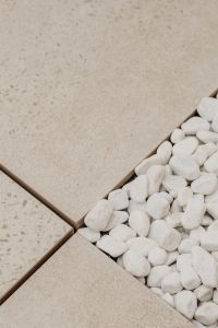 Kaboompics - Beige Textured Tile and White Pebbles in a Diagonal Minimal Composition