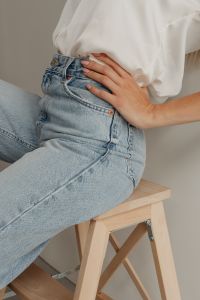 Kaboompics - Side Close-Up of Hand on Hip and Light Blue Jeans beneath White Shirt, Fashion Detail