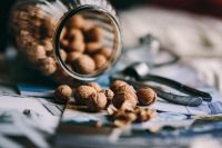 Kaboompics - Glass jar full of walnuts and a nutcracker
