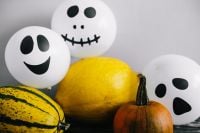 Kaboompics - Halloween Pumpkin Display with Ghost Balloons and Autumn Gourds