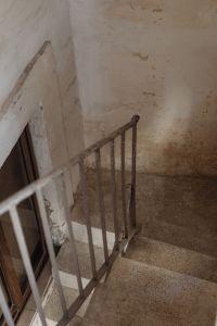 Kaboompics - Dim Interior Stairwell with Rusted Handrail and Peeling Plaster