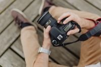 Kaboompics - Photographer holding a DSLR camera