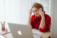 Kaboompics - Smiling Woman Talking on Phone with Laptop at Home Office
